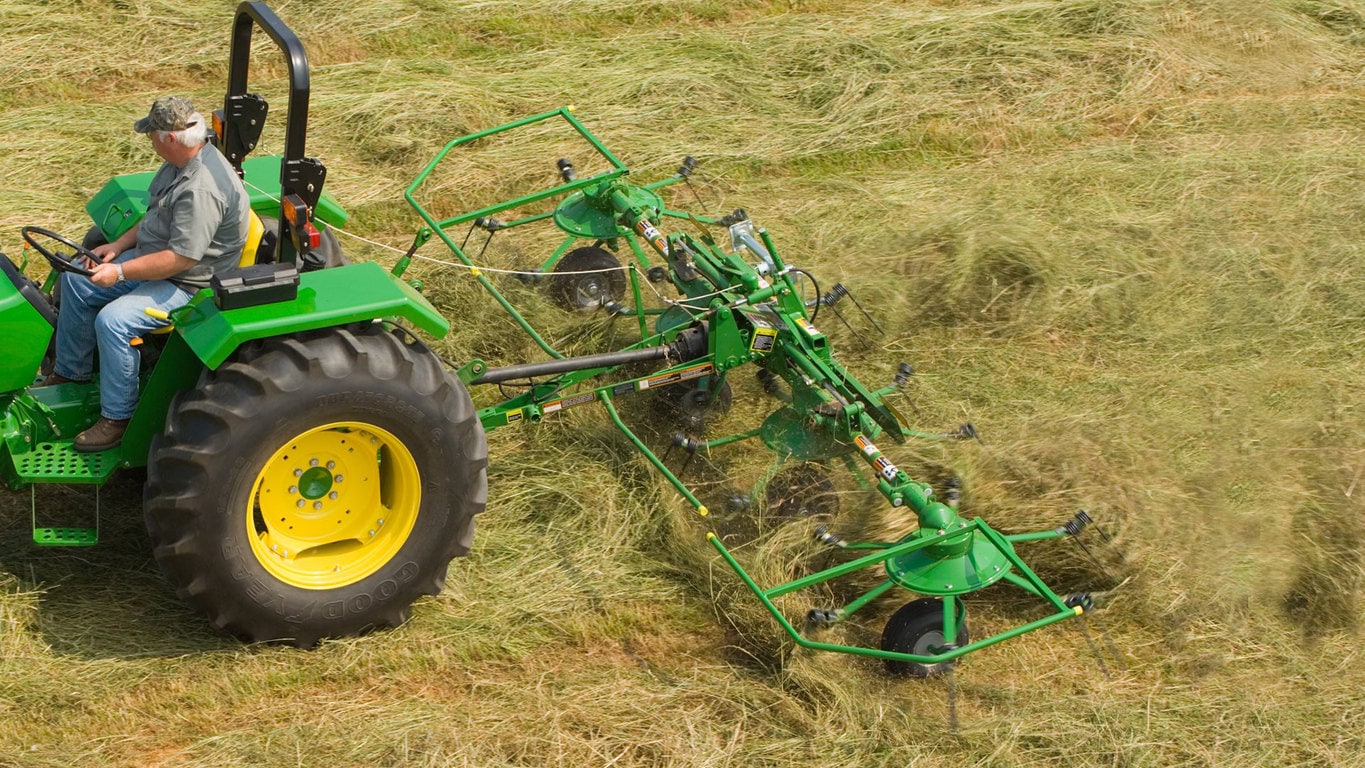 field image of Frontier™ td13 hay tedder attached to a tractor