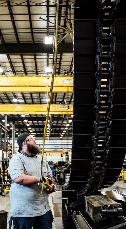 John Deere employee working on Excavator tracks