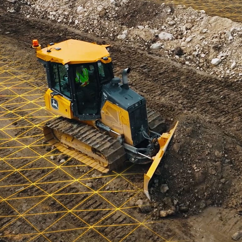 Dozer pushes a load of dirt with representative mapping of grade control technology on the jobsite