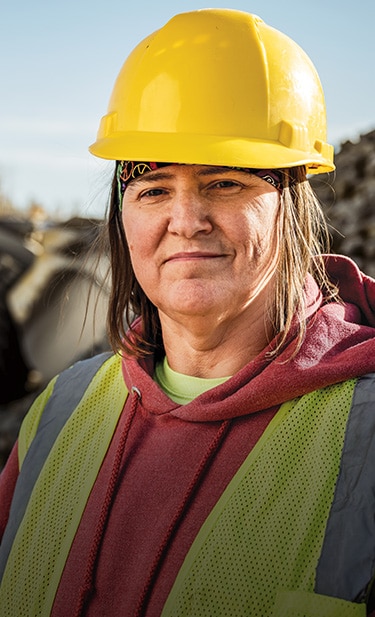 Lisa Nanninga is standing at a Rockridge Quarry site looking toward the camera.