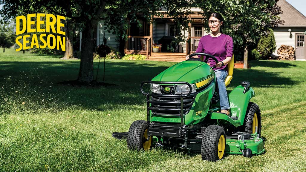 Person on an X590 Lawn Tractor cutting grass.
