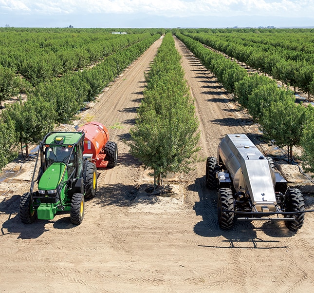 A tractor and a GUSS Sprayer in an orchard