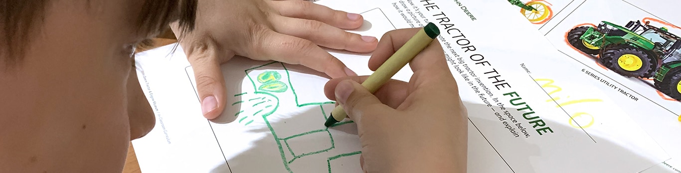 A boy drawing a tractor on an activity lesson