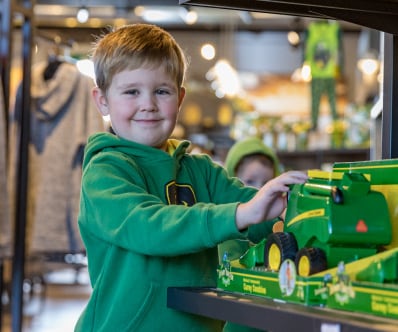 Young boy looking at a combine toy
