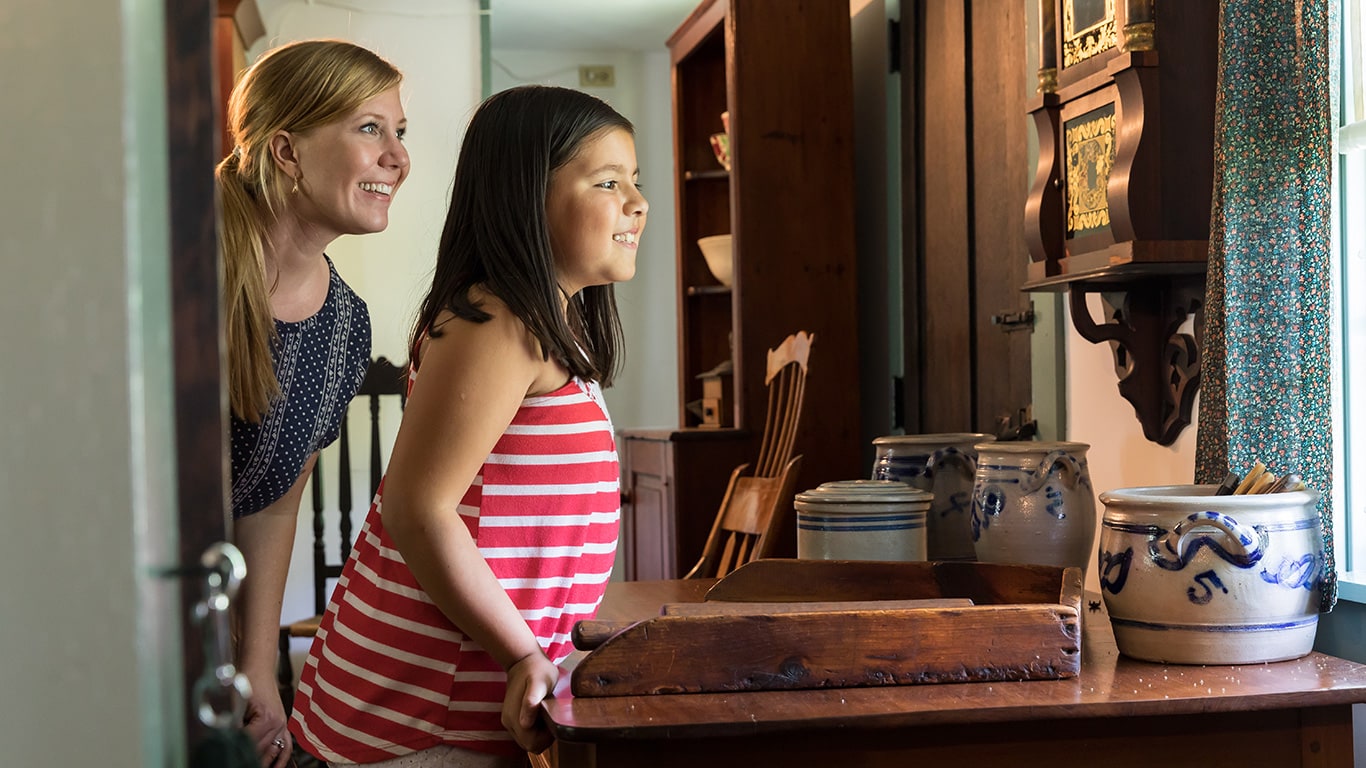 Mom and child inside of the John Deere family home.