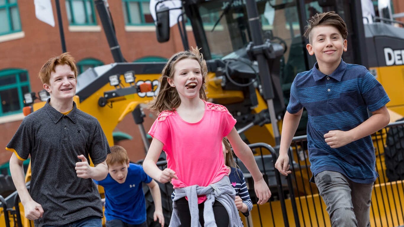 Kids running into the John Deere Pavilion