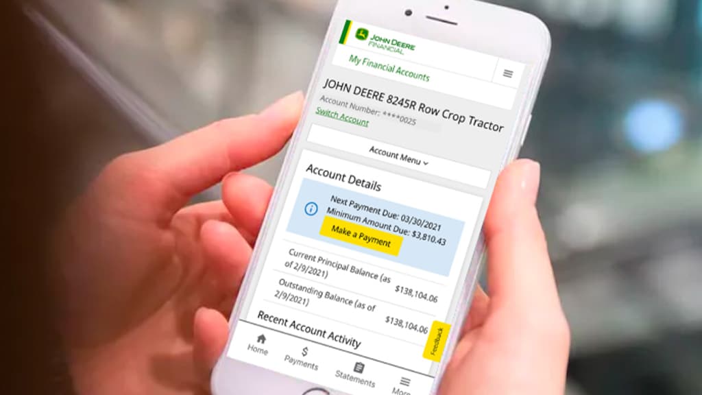 hands holding a phone displaying the John Deere Financial app