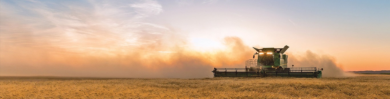 S series combine working field during sunset