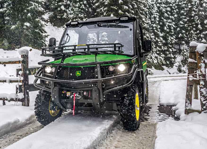 John Deere Gator Utility Vehicle on a path in the snow