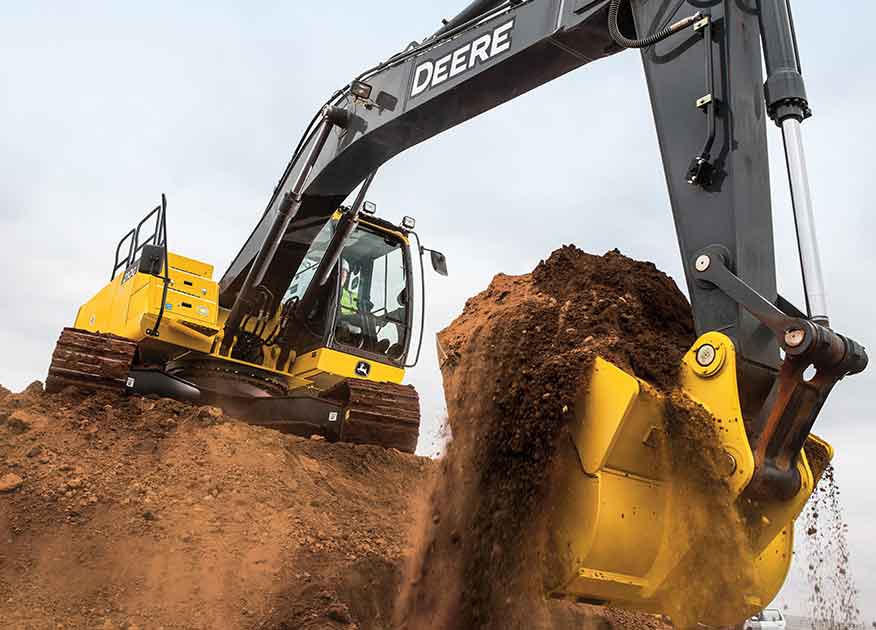 John Deere Construction equipment digging a hole in dirt