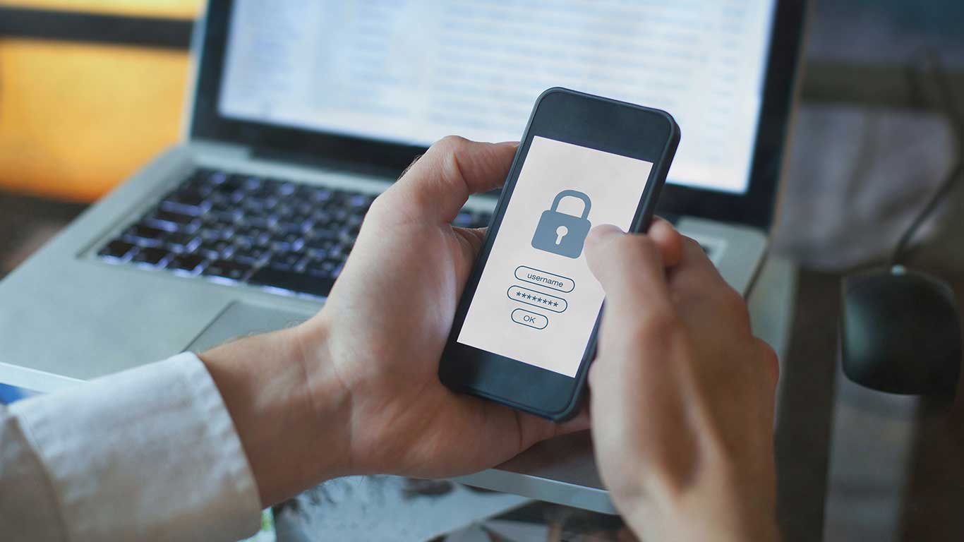Person holding a phone with a lock screen showing