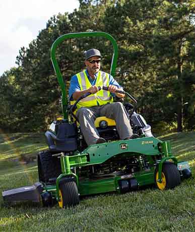 Man mowing grass on a John Deere ZTrak