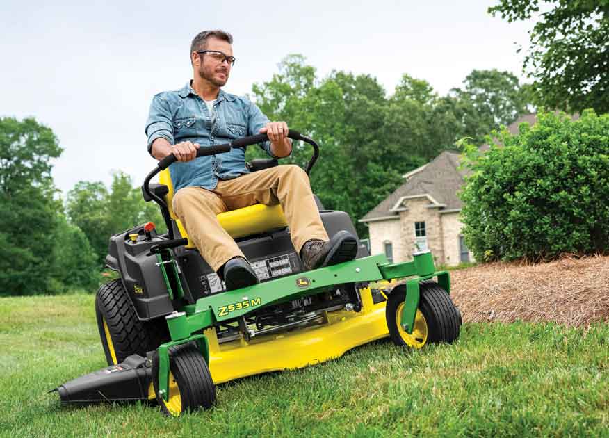 Man mowing a yard with a John Deere Z535M ZTrak Zero-Turn Mower