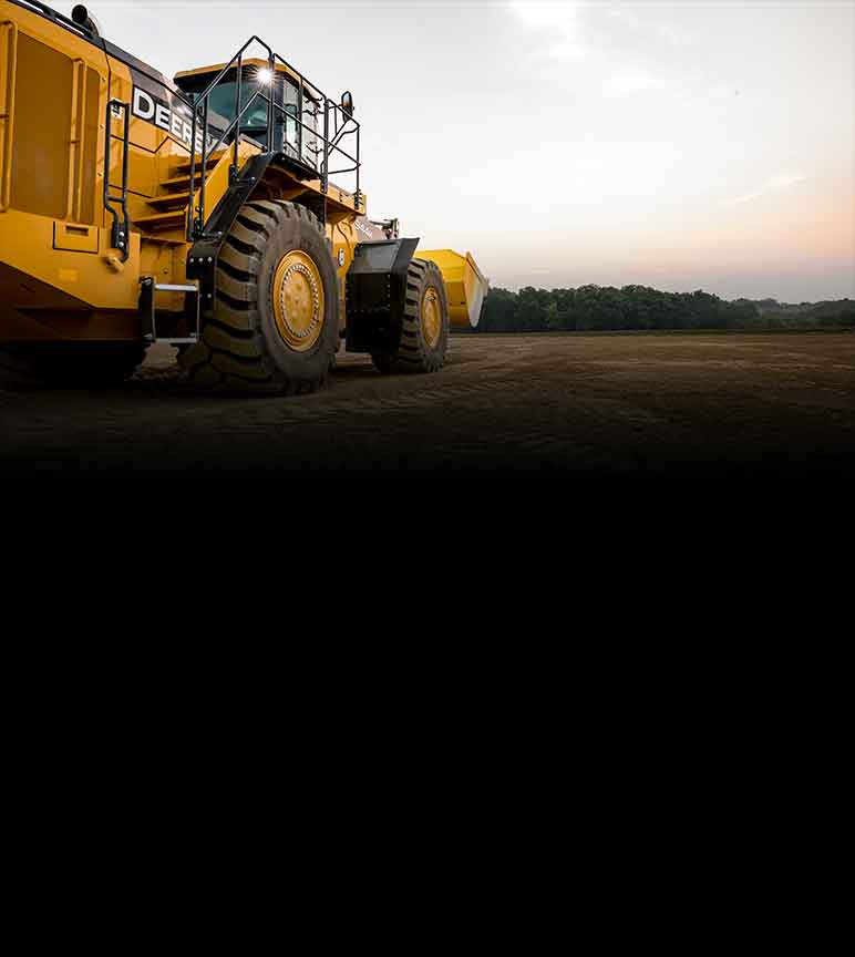 John Deere Construction equipment side view on an empty dirt plot