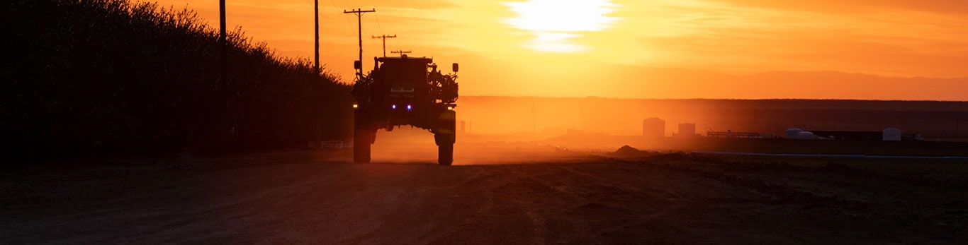 Self propelled sprayer during sunset