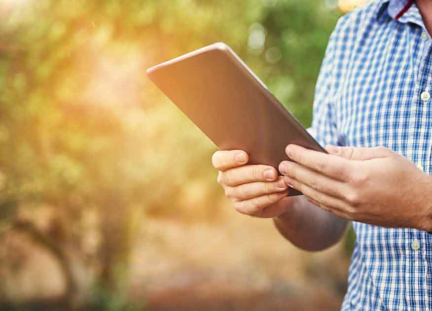 Close up of a man holding a tablet