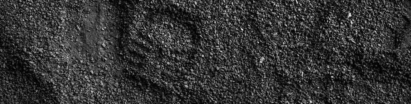 Bootprint in pile of dark gravel