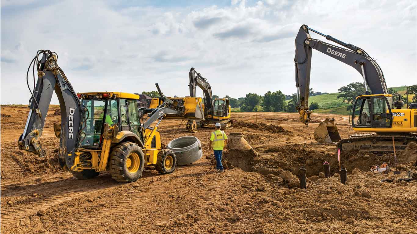 Construction site with man and John Deere Equipment