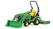 1025R equipped with a loader and box blade implements