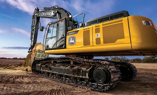 350G LC SmartGrade Excavator scoops a load of dirt.