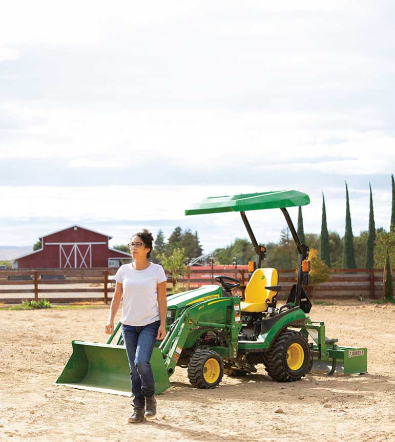 Woman walking away from 1 Series Compact Tractor