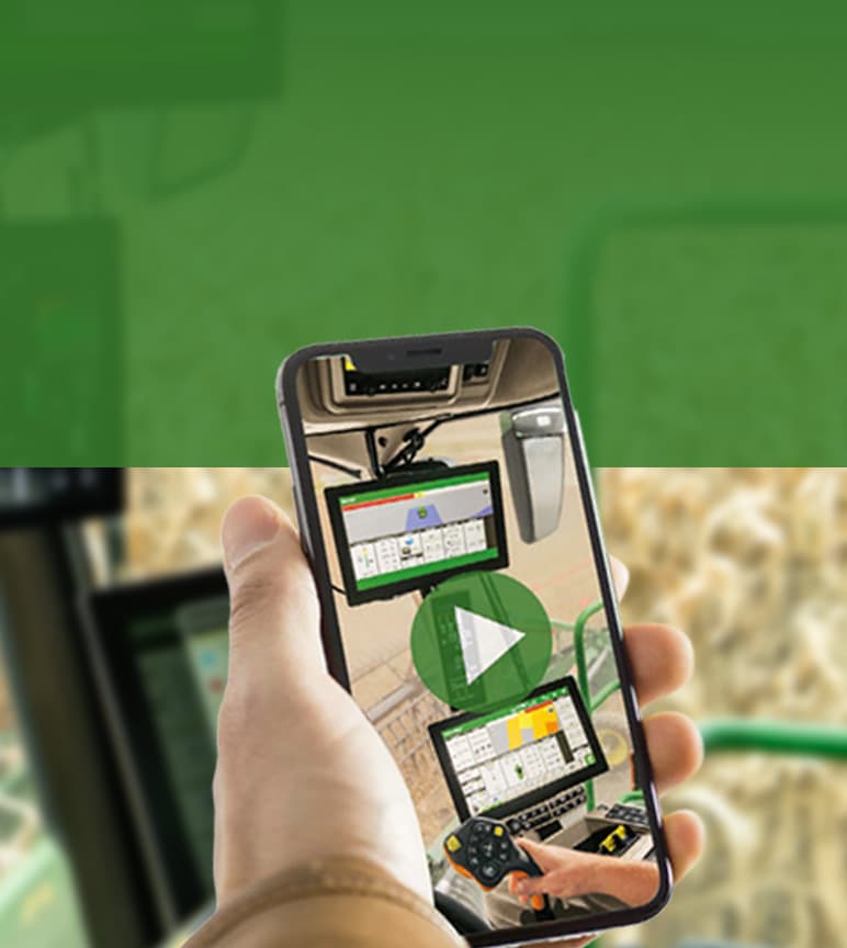 Image of someone taking a photo with a cell phone in a combine cab