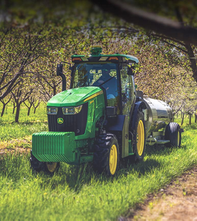 5 Series tractor moving between orchard rows