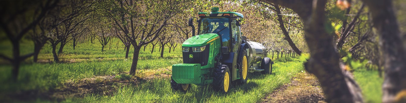 5 Series tractor moving between orchard rows