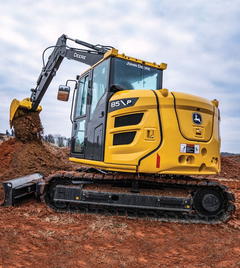 John Deere 85 P-Tier excavator working on job site and moving dirt with bucket.