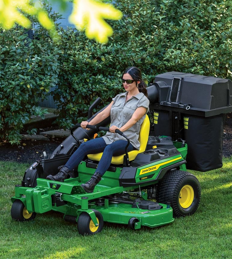 Woman mowing grass with John Deere Z325E Zero-Turn mower