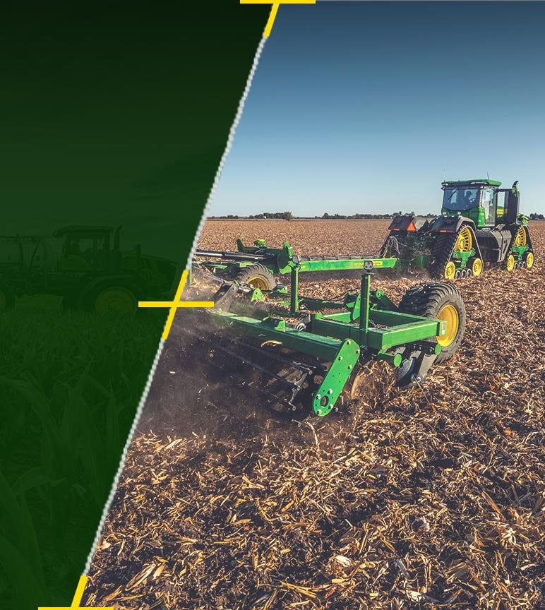 Tractor pulling tillage equipment through field.