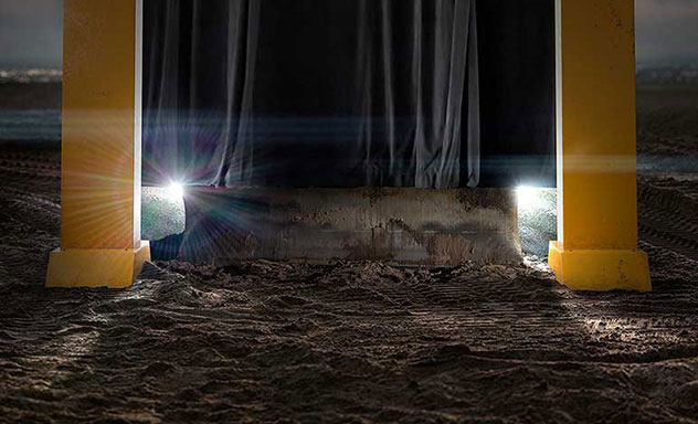 A curtain rises, revealing a machine blade between two pillars of a John Deere dealership sign.