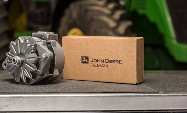Image of an Alternator and a John Deere Reman box with a John Deere 7930 tractor in the background.