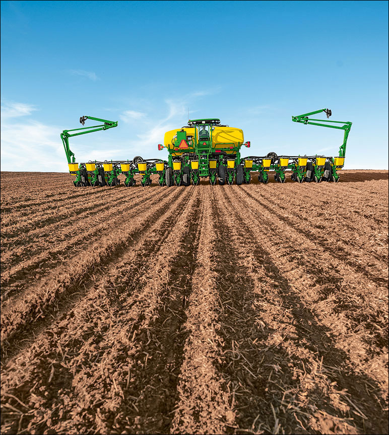 John Deere tractor and planter in the field.