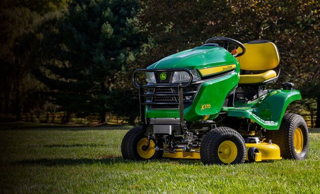 An X370 parked on grass with trees in the background.