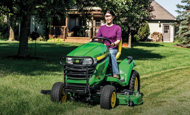 Person cutting lawn on X590 Select Series Lawn Tractor
