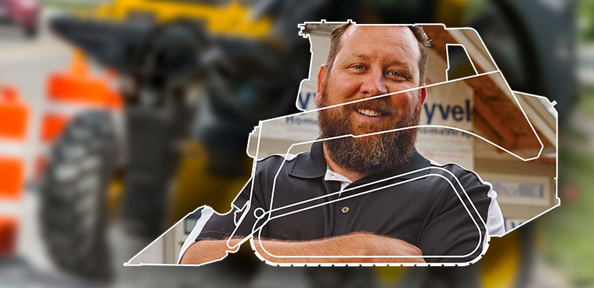 image of volunteer shown within the frame of a skid steer