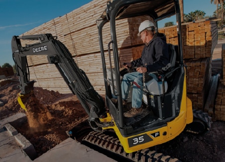 The words â€œcompact equipmentâ€ are on top of a John Deere 35 P-Tier Compact Excavator digging at a jobsite.