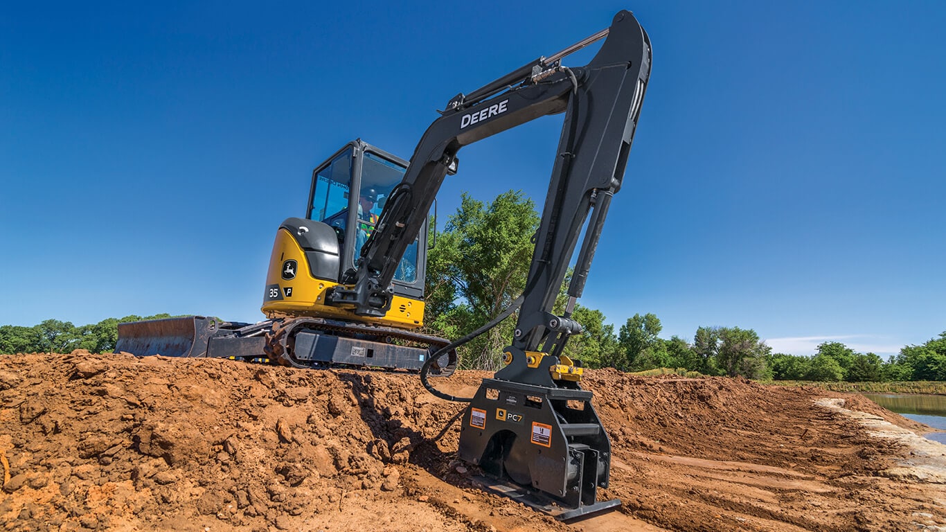35 P-Tier excavator using plate compactor on job site.