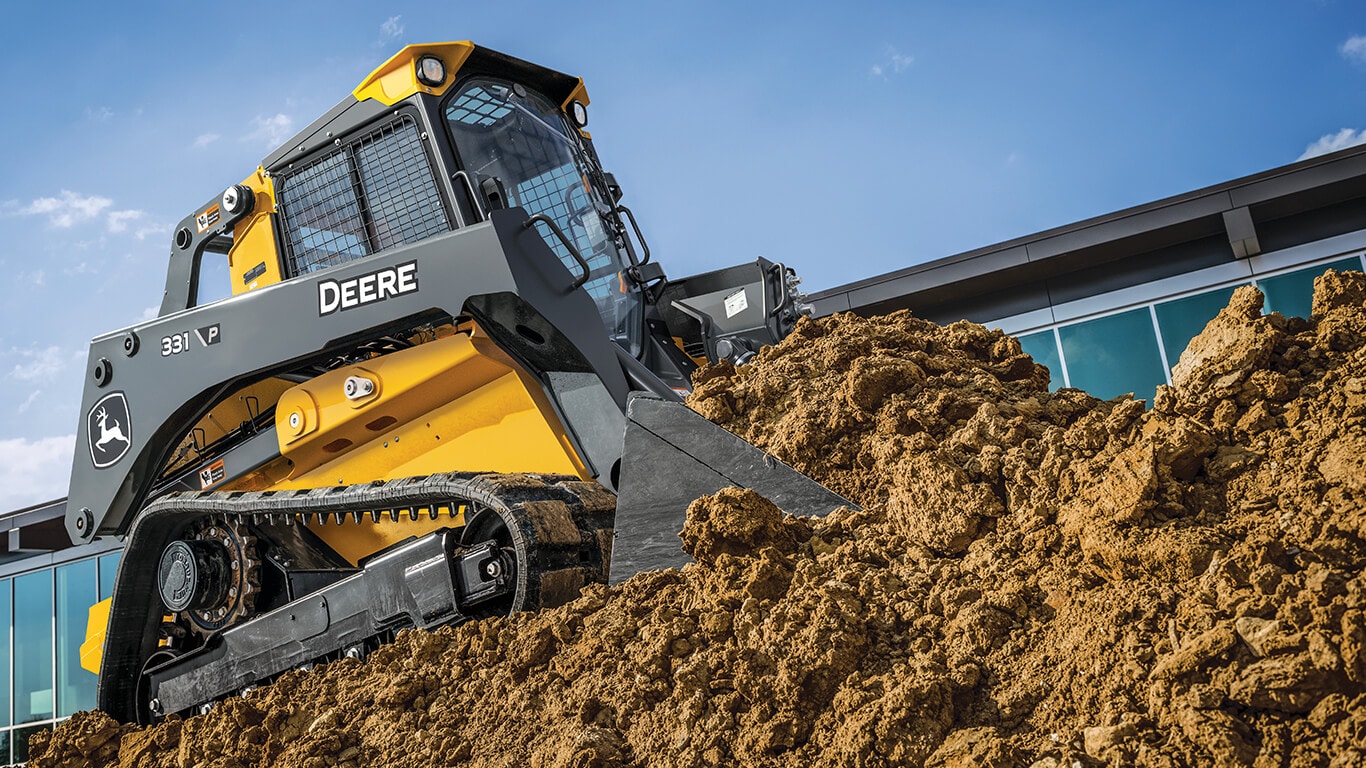John Deere 331 P-Tier compact track loader moving dirt on jobsite.