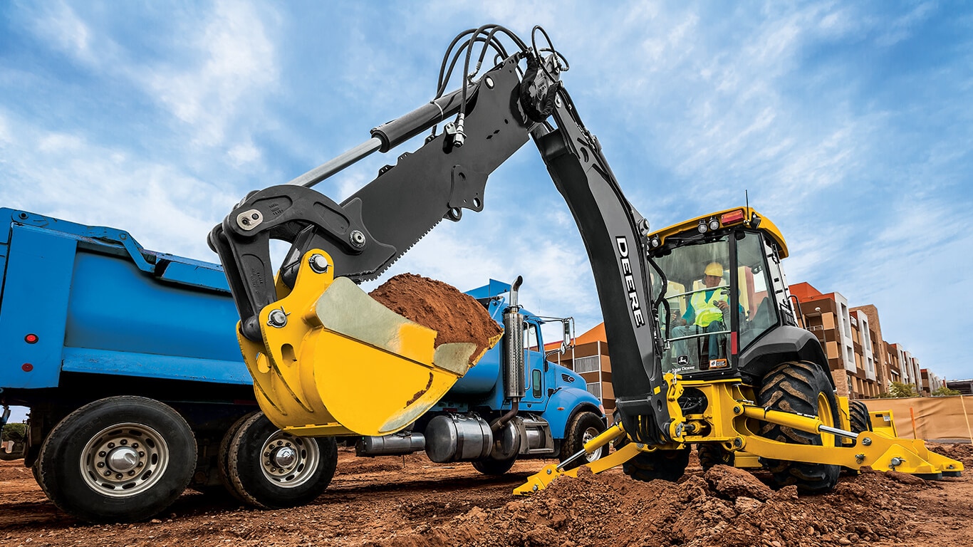 A backhoe moving dirt on the job site.