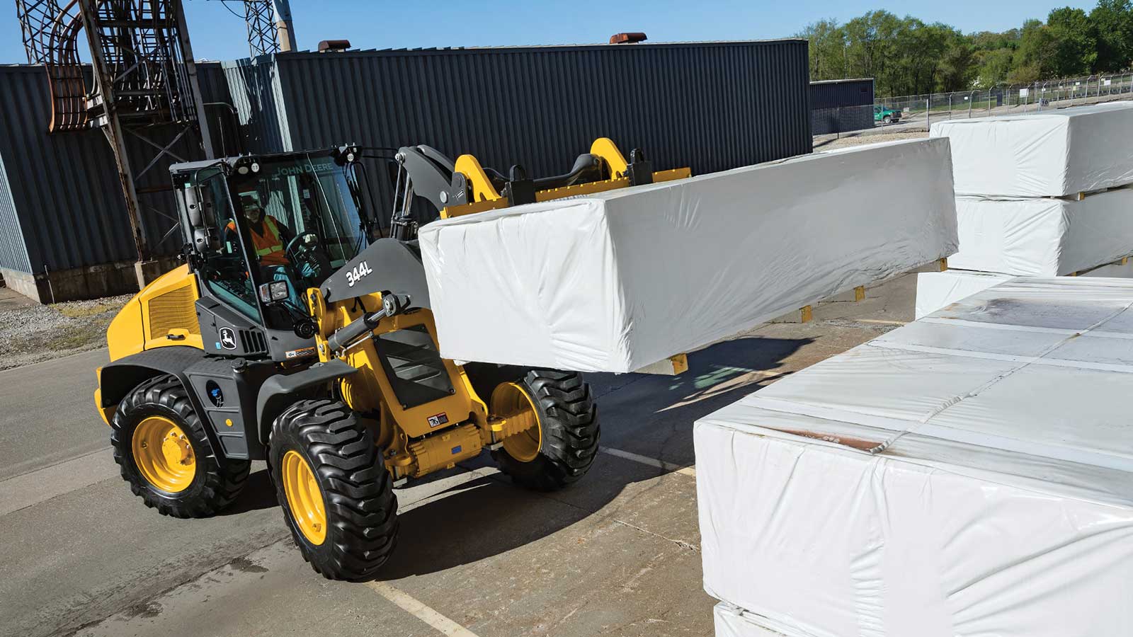 344L Compact Wheel Loader moving pallets