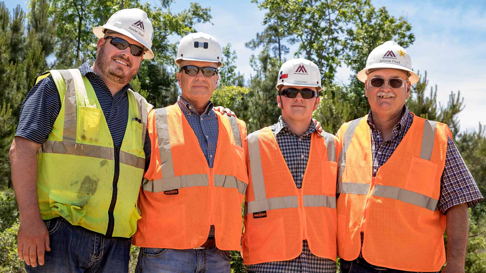 Mike Cagle and son stand with a couple members of the Mica Enterprises’ crew.