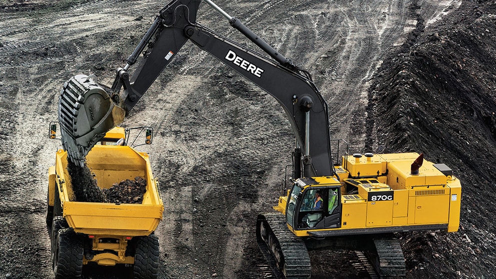 Excavator loading an ADT