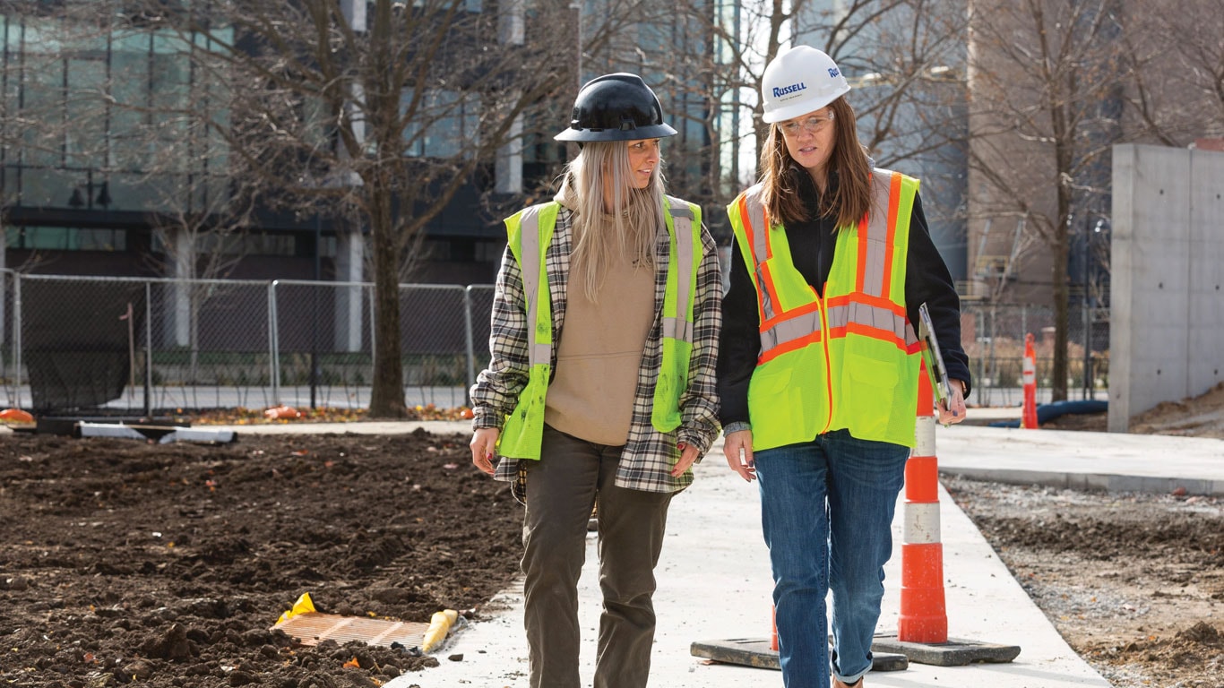 Russell women walk through the jobsite