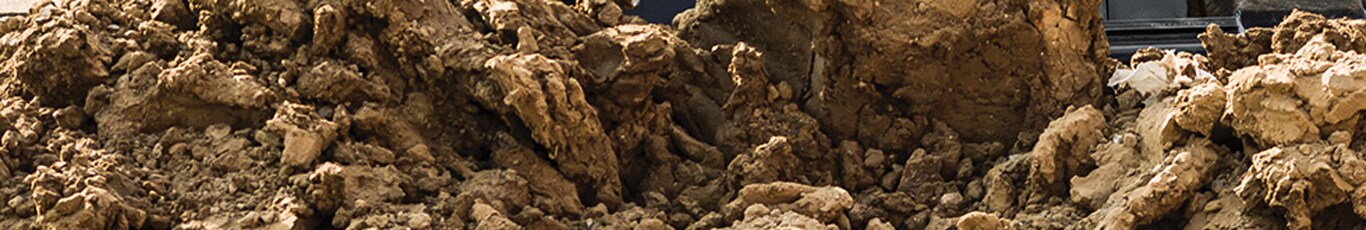 Close up of a dozer pushing a large pile of dirt