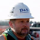 Mike Brown, owner of B&S Site Development, wearing a hardhead in outdoor photo