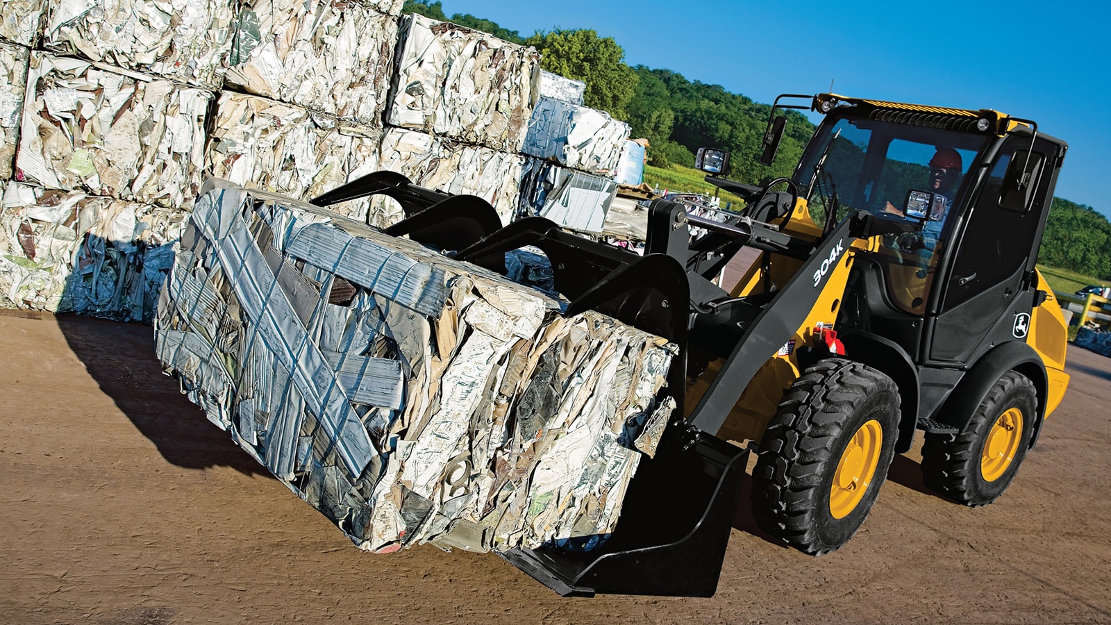 Scrap Grapple on a 304K Wheel Loader moving a load of scrap
