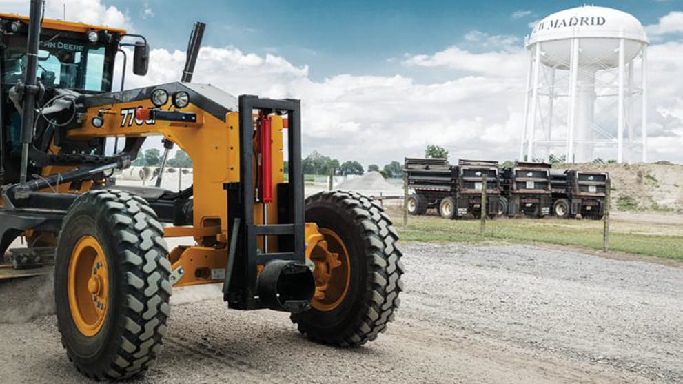 motor grader next to New Madrid water tower