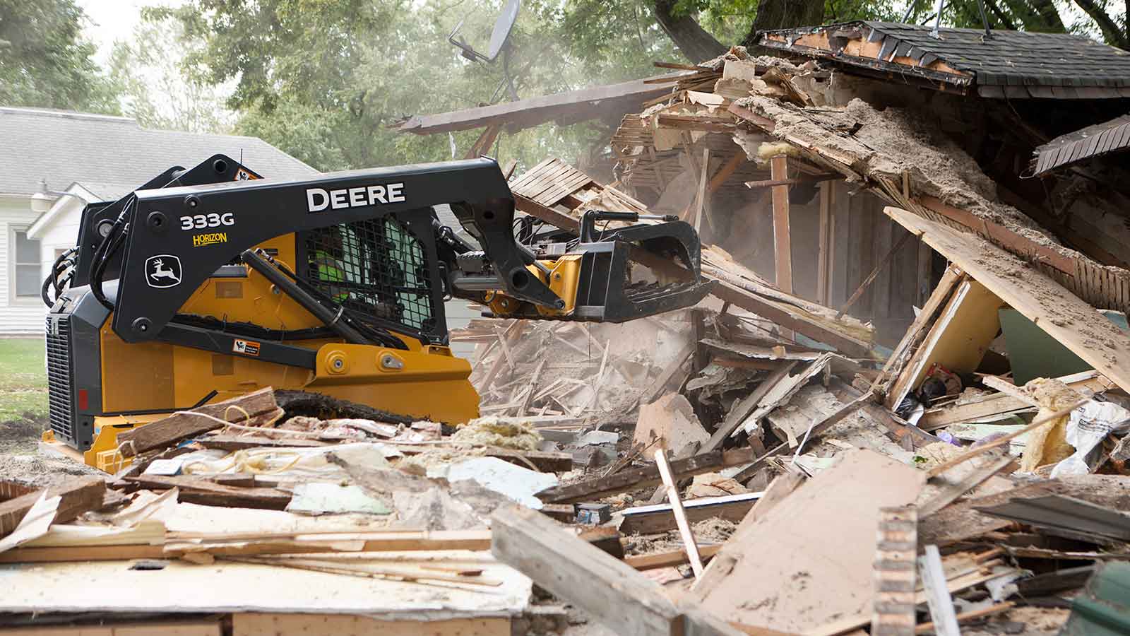 Moore uses the 333G compact track loader to demolish an old house.